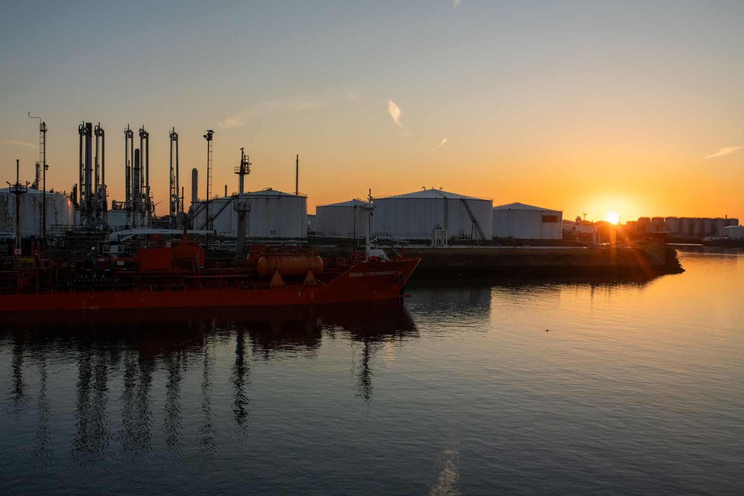 industrial port at sunrise with tanker ship