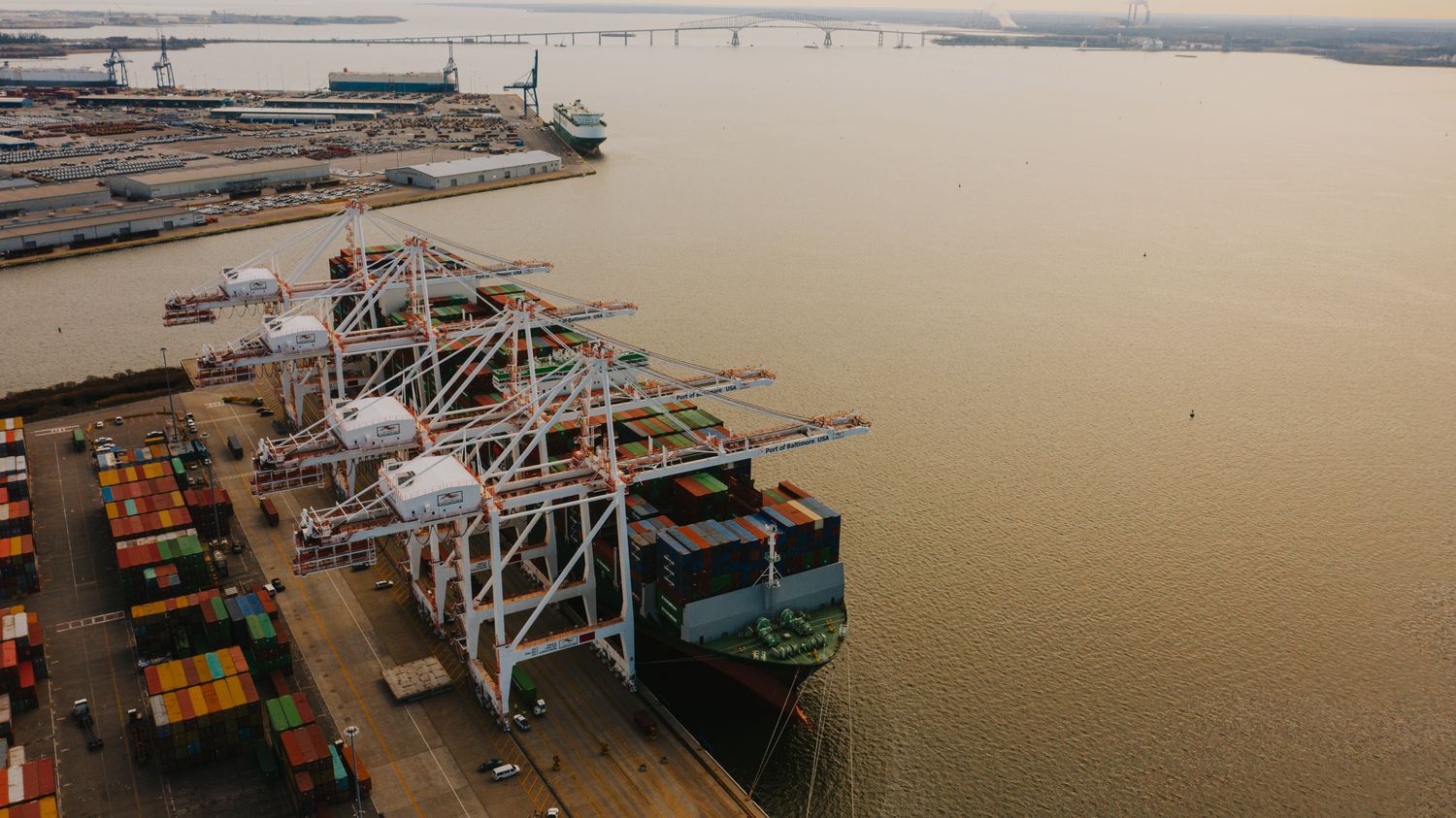 lifting cranes loading ship with cargo containers